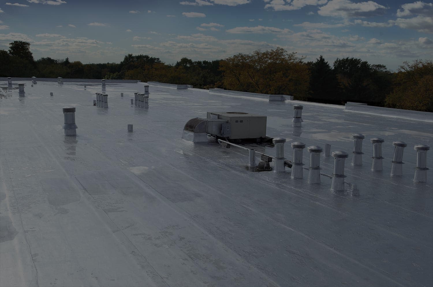 Restored low-slope commercial roof with rooftop equipment